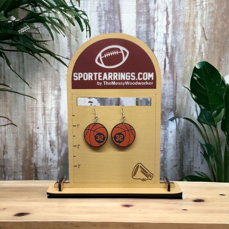 Personalized basketball earrings with a players jersey number. Made from lightweight acrylic, they measure 1/8" thick and 1.15" round. Great gift idea for basketball moms!