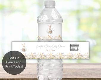 May include: Water bottle label with a white background and a watercolor illustration of a bunny holding a basket of eggs. The label also includes the text "Jenifer & Dave's Baby Shower" and the date "04.22.20xx".