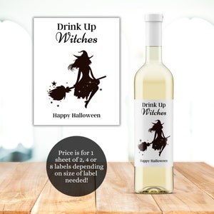 May include: A white wine bottle with a black and white label featuring a witch flying on a broomstick. The label reads "Drink Up Witches" and "Happy Halloween".