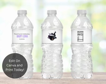 May include: Three clear plastic water bottles with labels. The center bottle has a label with a black cauldron and purple text that says "Thank You for Celebrating Baby Luna 11.22.20XX". The bottle on the right has a label with the words "Baby Shower Nutrition Facts".