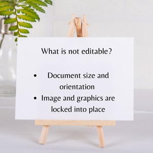 May include: A white card on a wooden easel with black text that reads "What is not editable?"  The text below the question reads "Document size and orientation" and "Image and graphics are locked into place."