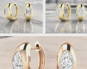 May include: Gold hoop earrings with a rectangular-cut diamond. Another pair of gold hoop earrings with a round-cut diamond. A pair of rose gold hoop earrings with a pear-shaped diamond.