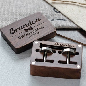 a pair of wooden cufflinks sitting on top of a table