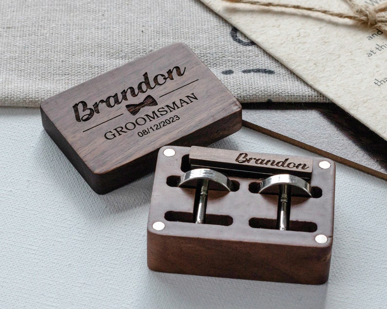 a pair of wooden cufflinks sitting on top of a table