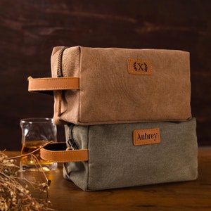 a brown and grey bag sitting on top of a wooden table