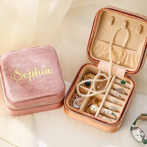 a pink case with jewelry inside of it