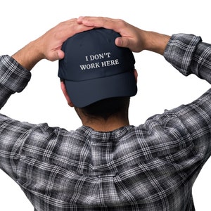 Let your cap do the talking! Our "I Don't Work Here" cap is a fun and casual addition to your wardrobe, ideal for expressing a laid-back attitude with a touch of humor.