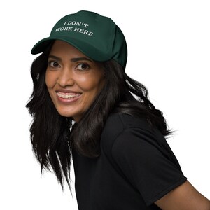 Embrace the playful side of fashion with our "I Don't Work Here" cap. Whether you're running errands or just enjoying a casual day out, this cap is the perfect blend of wit and style.