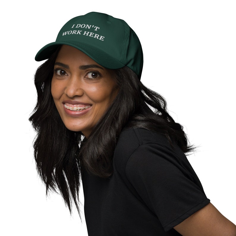 Embrace the playful side of fashion with our "I Don't Work Here" cap. Whether you're running errands or just enjoying a casual day out, this cap is the perfect blend of wit and style.