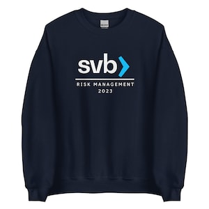 May include: Navy blue sweatshirt with a white logo that says "svb" with a blue arrow pointing to the right. Below the logo, it says "RISK MANAGEMENT 2023".
