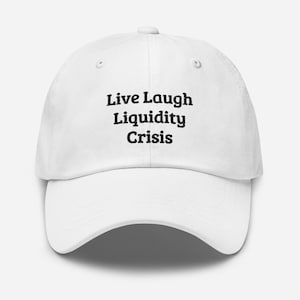 May include: White baseball cap with the text "Live Laugh Liquidity Crisis" in black, centered on the front. The cap has a curved brim and a button on top. The hat is made of a soft material.