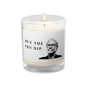 May include: A white candle in a clear glass jar with a black and white image of a man and the text "BUY THE FKN DIP."