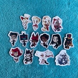 May include: A collection of die-cut stickers featuring various cartoon characters. The stickers showcase characters with distinct features, including varied hairstyles, clothing, and accessories. The stickers are on a turquoise background.