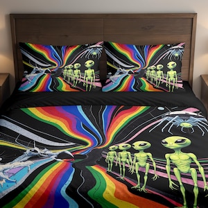 May include: A black and colorful bedding set featuring a vibrant, psychedelic design. The set includes a duvet cover and two pillowcases, all adorned with a repeating pattern of green aliens, rainbow streaks, and space-themed elements.