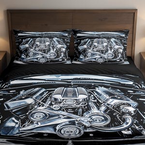 May include: Black and white bedding set featuring a detailed illustration of a car engine. The set includes a duvet cover and two pillowcases. The design showcases the engine's intricate components, with a focus on chrome and metallic elements.