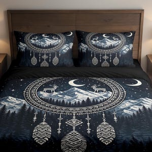 May include: Dark blue bedding set featuring a mountain and deer design. The set includes a duvet cover and two pillowcases. The design features a circular pattern with deer, mountains, and a crescent moon. The color palette includes shades of blue and white.