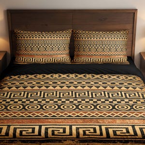 May include: A bed with a dark wooden headboard and matching nightstands. The bed is made with a black comforter and two pillowcases. The pillowcases and comforter feature a geometric pattern in shades of brown, black, and gold. Two lamps with white shades sit on the nightstands.