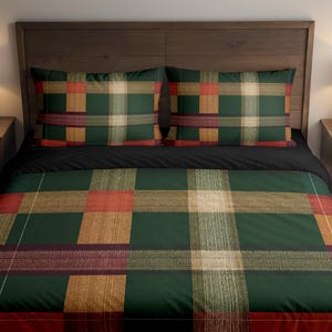 May include: A bed with a dark wooden headboard, featuring a green, red, and tan plaid pattern duvet cover and two matching pillowcases. The bed has a black sheet. Two bedside tables with lamps are on either side.