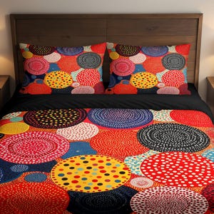 May include: A bed with a wooden headboard, featuring a duvet cover and two pillowcases. The bedding has a vibrant pattern of colorful circles in red, yellow, blue, and black. The bed is made up with a black sheet.