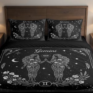 May include: Black bedding set featuring a Gemini zodiac design. The set includes a duvet cover and two pillowcases. The design features two figures, flowers, stars, and the word "Gemini" in white.