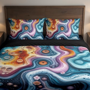 May include: A bed set featuring a colorful abstract design. The bedding includes a duvet cover and two pillowcases. The pattern has swirls of blue, orange, purple, and pink, with a black sheet underneath. The bed is set against a wooden headboard.