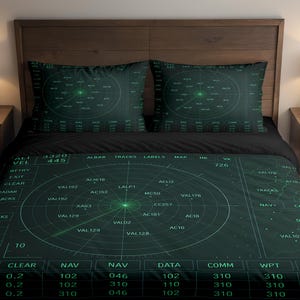 May include: Dark green radar-themed bedding set with a detailed circular graphic on the duvet cover and pillowcases. The design includes text and lines resembling a radar display. The set is on a bed with a wooden headboard.