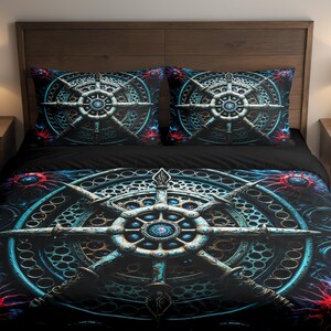 May include: A black bed set featuring a detailed, circular design in shades of teal, blue, and silver. The design is repeated on the duvet cover and two pillowcases. The bedding has a dark, almost space-like theme.