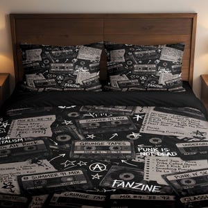 May include: A black and white bedding set featuring a repeating pattern of vintage cassette tapes, handwritten tracklists, and various music-themed text including "Grunge Tapes," "Punk Is Not Dead," and "Fanzine" printed on the duvet cover and pillows.