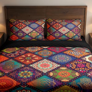 May include: A bed with a dark wooden headboard, featuring a colourful quilt and two matching pillowcases. The quilt and pillowcases have a patchwork design with geometric and floral patterns in shades of red, blue, green, and purple. The bed has a black sheet.