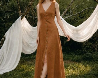 May include: A sleeveless, ankle-length dress in a solid rust-brown color. The garment features a V-neckline and a full-length front button placket with matching buttons. The skirt has a relaxed, A-line silhouette with a subtle front slit opening.