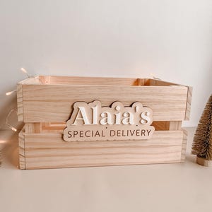 May include: A natural wood crate with a personalised sign that reads "Alaia's Special Delivery".