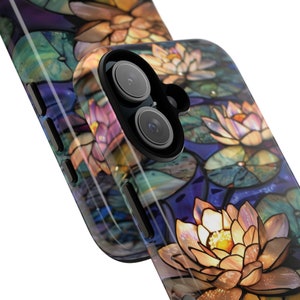 May include: A phone case with a stained glass design featuring water lilies in shades of purple, blue, green, and gold.