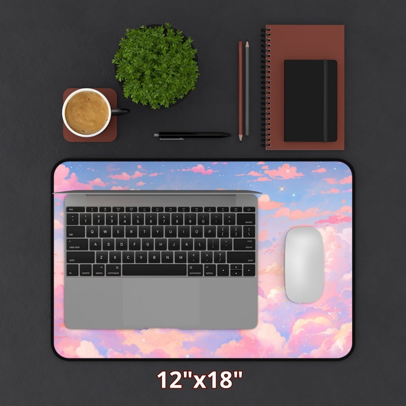 May include: A pink and blue cloud-themed mousepad with a laptop and mouse on top. The mousepad is 12 inches by 18 inches.