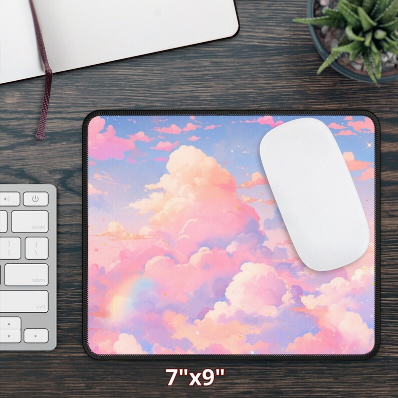 May include: A pink and blue mouse pad with a cloud and rainbow design. The mouse pad is 7 inches by 9 inches.