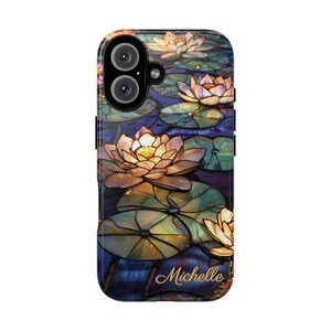 May include: A phone case with a stained glass design featuring water lilies in shades of blue, green, and yellow. The name "Michelle" is printed in gold script at the bottom of the case.