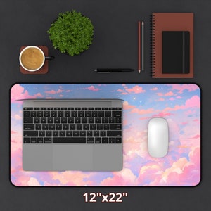 May include: A pink and blue desk mat with a cloud and star design. The mat is 12 inches by 22 inches.