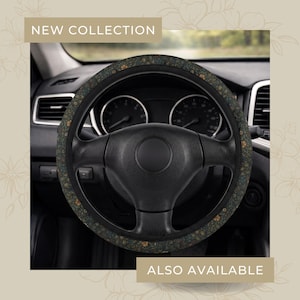 May include: A black steering wheel with a floral patterned cover. The cover features a dark green background with small yellow and blue flowers. The text "NEW COLLECTION" and "ALSO AVAILABLE" are visible.
