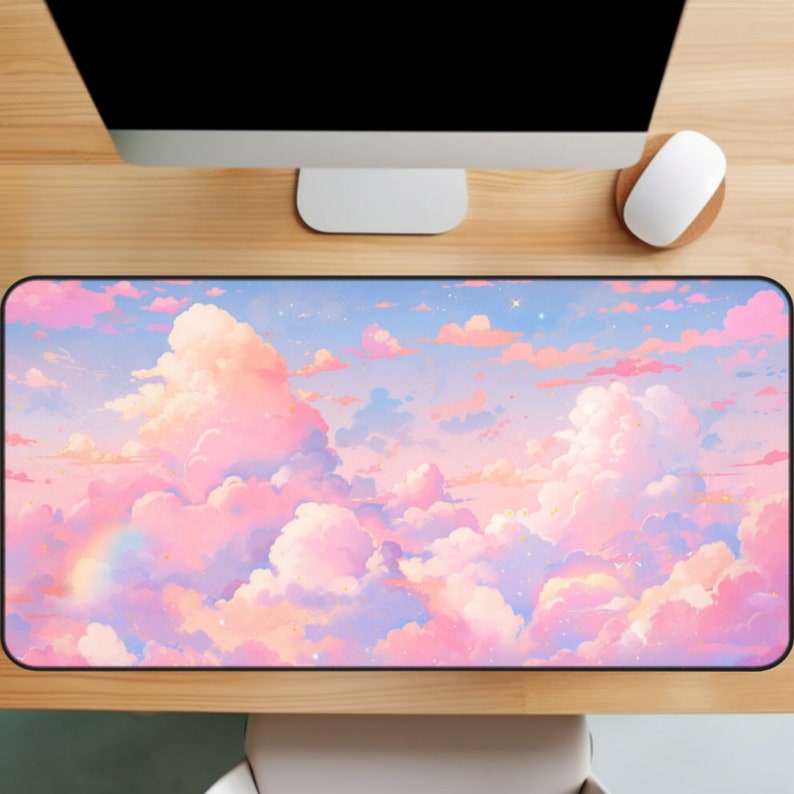 May include: A pink and blue mouse pad with a design of fluffy clouds and a rainbow. The clouds are a light pink and the background is a light blue with a few white stars.