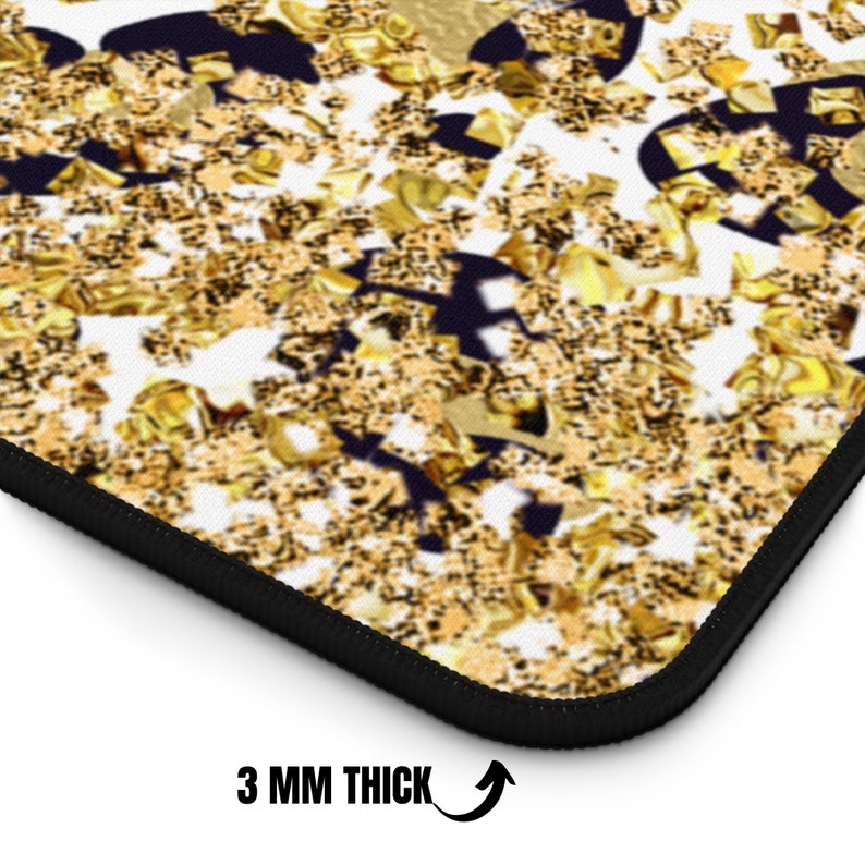 May include: A close-up of a decorative mousepad with a black border. The surface features a gold confetti design on a white background with dark blue accents. The mousepad is 3 mm thick.