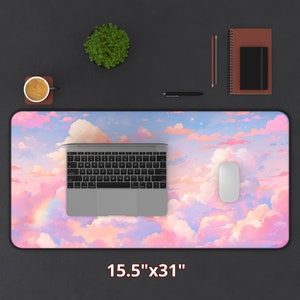 May include: A pink and blue desk mat with a cloud and star design. The mat is 15.5 inches by 31 inches.