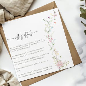 May include: Wedding details card with a floral design. The card includes information about the wedding ceremony and reception, including the date, location, and dress code. The text reads "wedding details" and "We are delighted to invite you to join us in celebrating the union of our hearts in the sacred bond of marriage."