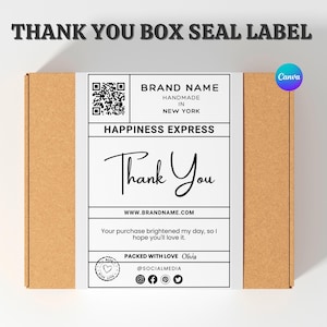 May include: A brown cardboard box with a white label that reads "THANK YOU" in elegant script. The label includes a QR code, brand information, and social media icons. The text "HANDMADE IN NEW YORK" is also visible.