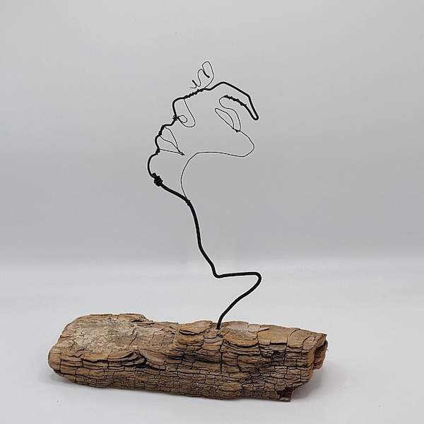 Face woman made of wire, wire figure, handwork, wood