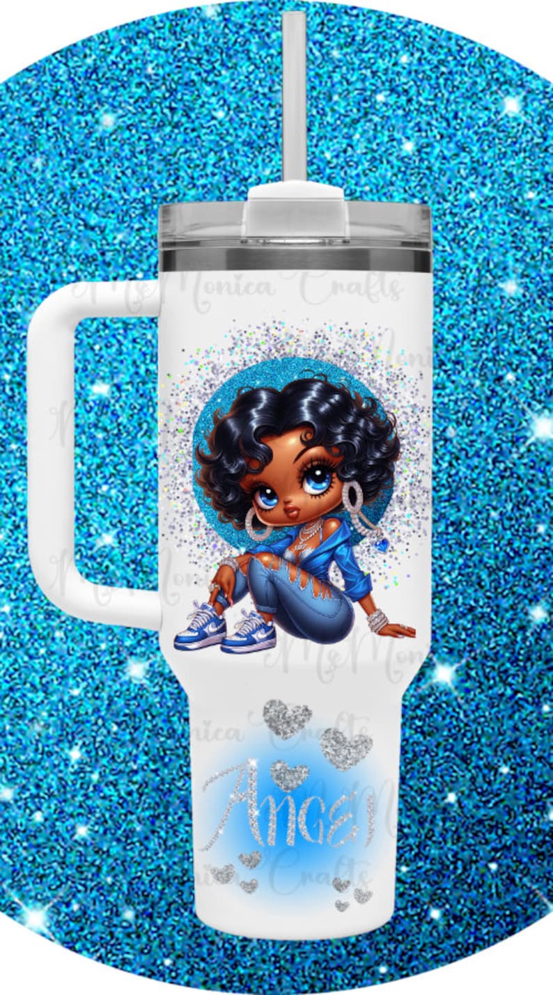 May include: White tumbler with a handle, featuring a cartoon illustration of a woman in blue clothing, surrounded by a blue glitter circle. The word "Angel" is written in blue glitter. Includes a white lid and straw.