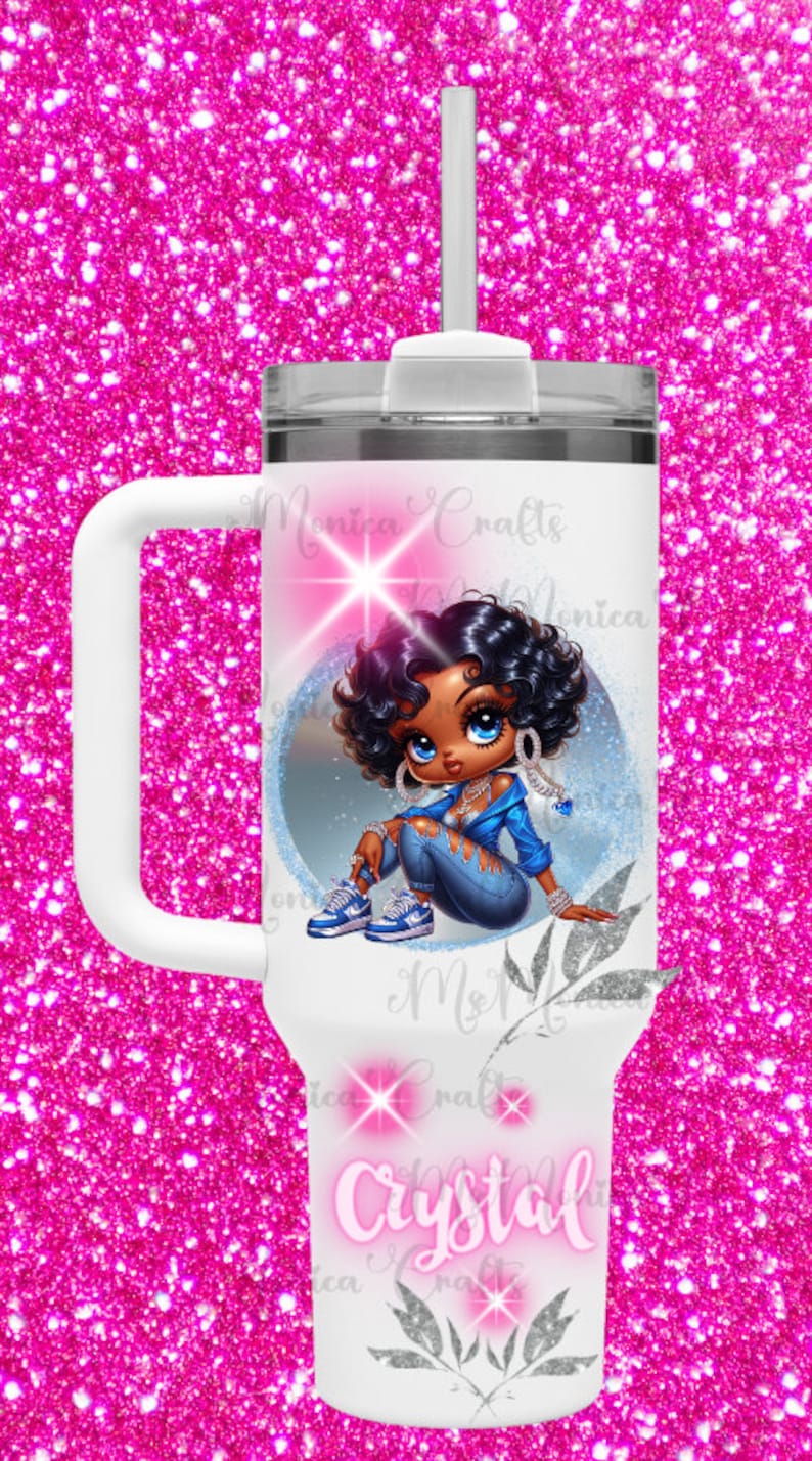 May include: White tumbler featuring a cartoon illustration of a Black girl in a blue jacket and jeans. The tumbler has a white handle, a clear lid, and a white straw. The name "Crystal" is written on the tumbler.