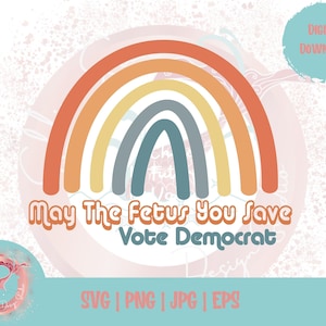 May include: A rainbow with a message that reads "May The Fetus You Save Vote Democrat". The rainbow is in shades of orange, yellow, blue, and gray. The background is a light pink with white speckles.