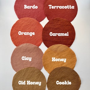 May include: Eight fabric swatches in various shades of brown, orange, and red. The swatches are labelled with the following names: Bardo, Terracotta, Orange, Caramel, Clay, Honey, Old Honey, and Cookie.