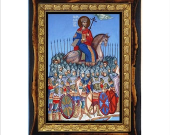 May include: A framed religious icon depicting a figure on horseback, holding a cross, leading a group of soldiers. The icon features vibrant colors, including red, blue, and gold, and is set within a dark wooden frame with a gold inner border. The image is on a white background.