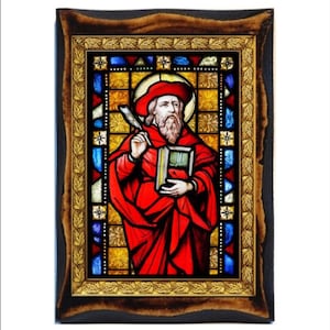 May include: A stained glass window depicting a man in a red robe holding a book and a quill. The window is framed in a dark wood frame with a gold leaf border.