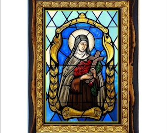 May include: A stained glass framed image of a woman in a brown robe holding a cross and a bouquet of red roses. The background is blue and gold.
